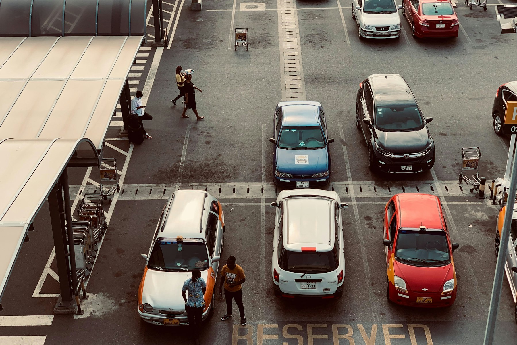 Cars waiting in an Accra airport parking area