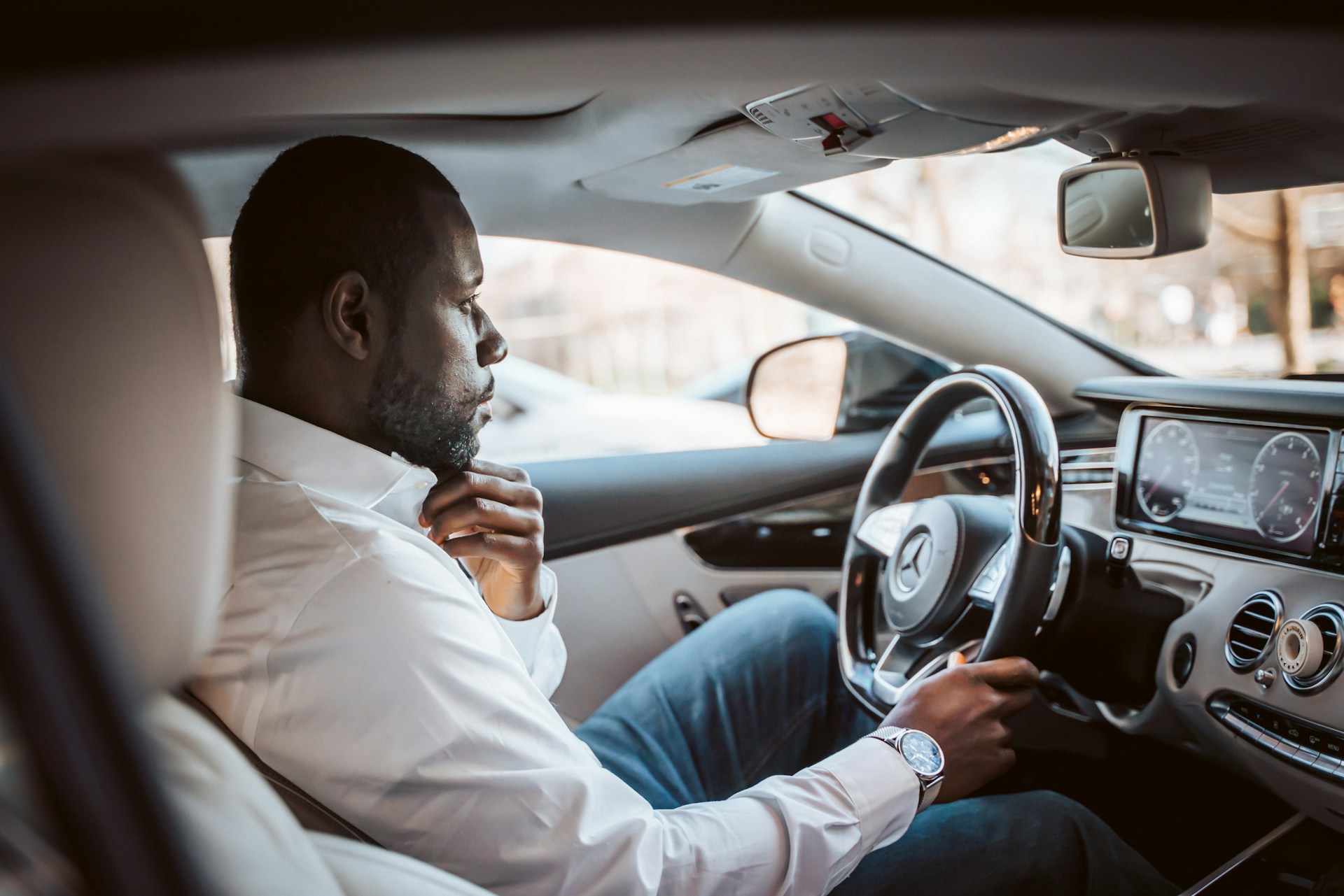 A passenger stepping into a waiting car at the kerb in Accra