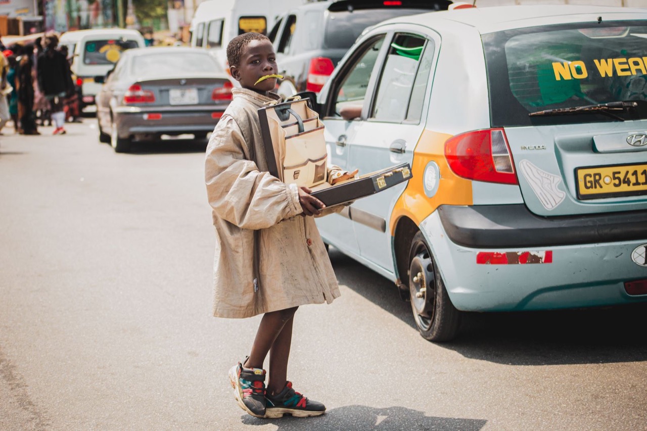 A street trader at work on a busy Accra roadside